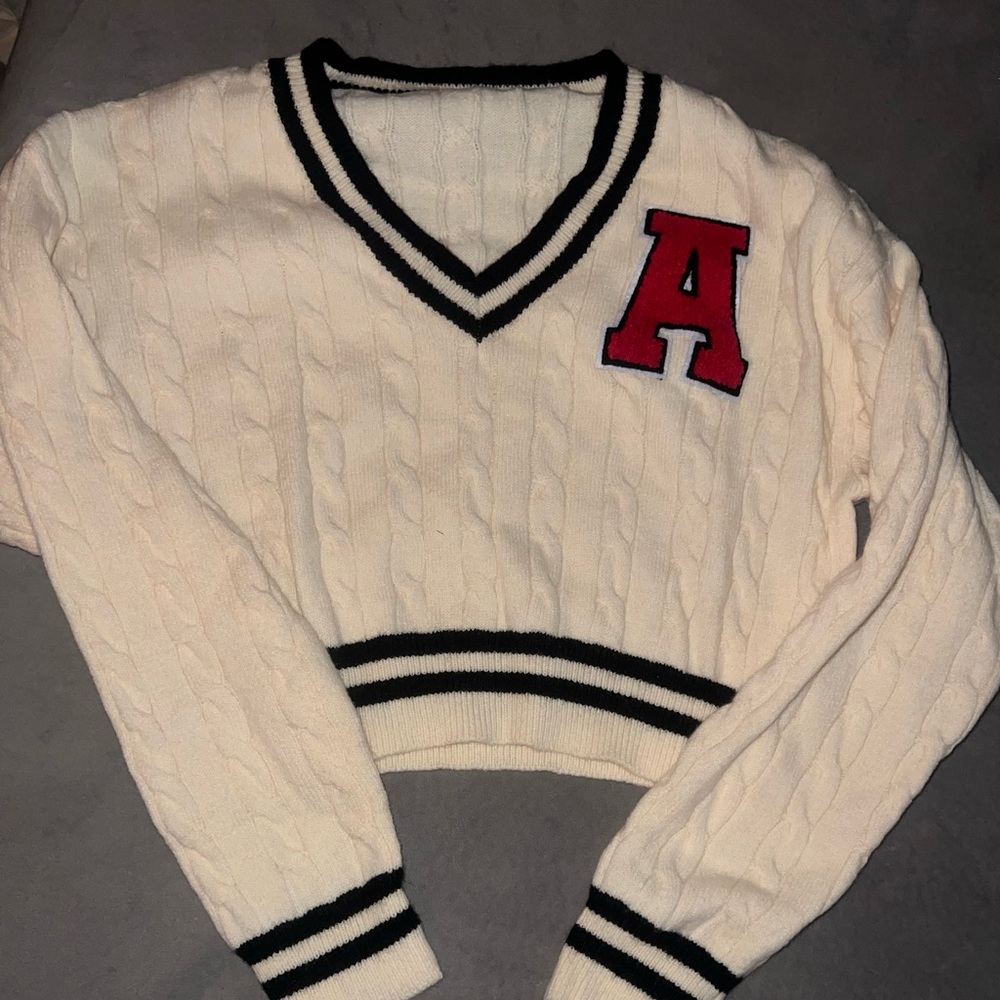 Ivory Cable Knit V-Neck Sweater with Black Trim & Red Patch A